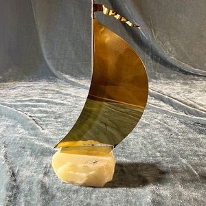Vintage sailboat figurine on rock